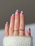 Load image into Gallery viewer, Hand with pink nail polish and rings on a neutral background
