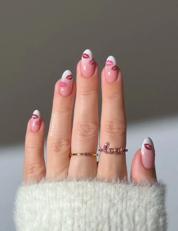 Hand with pink nail polish and rings on a neutral background