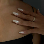Load image into Gallery viewer, Close-up of a hand with long, white nail polish on a dark background
