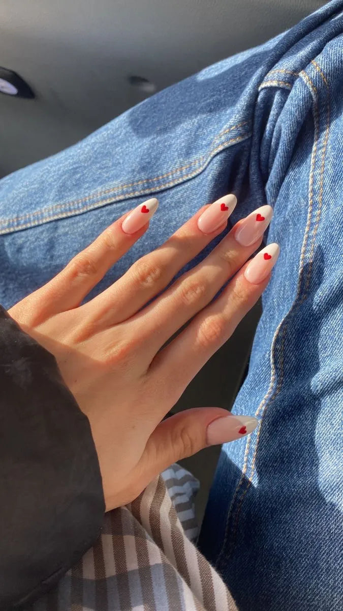 Hand with painted nails against a denim background