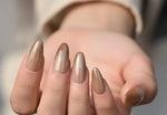 Load image into Gallery viewer, Close-up of a hand with beige nail polish on a blurred background

