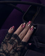 Load image into Gallery viewer, Hand with pink nail polish wearing a black lace glove against a dark background
