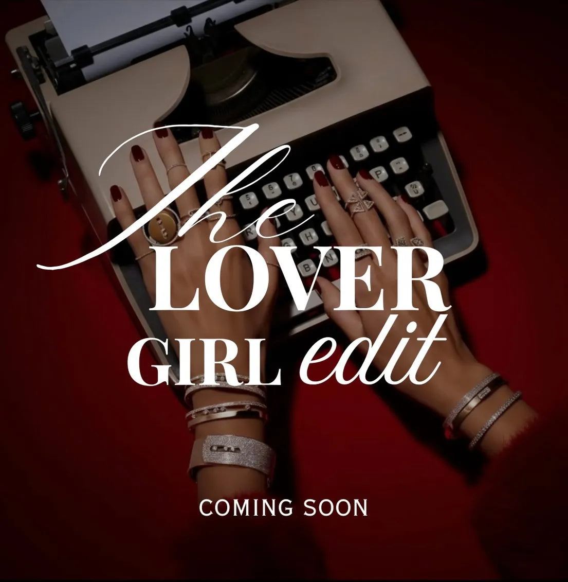 Person typing on a vintage typewriter with text overlay 'the lover girl edit coming soon' on a red background